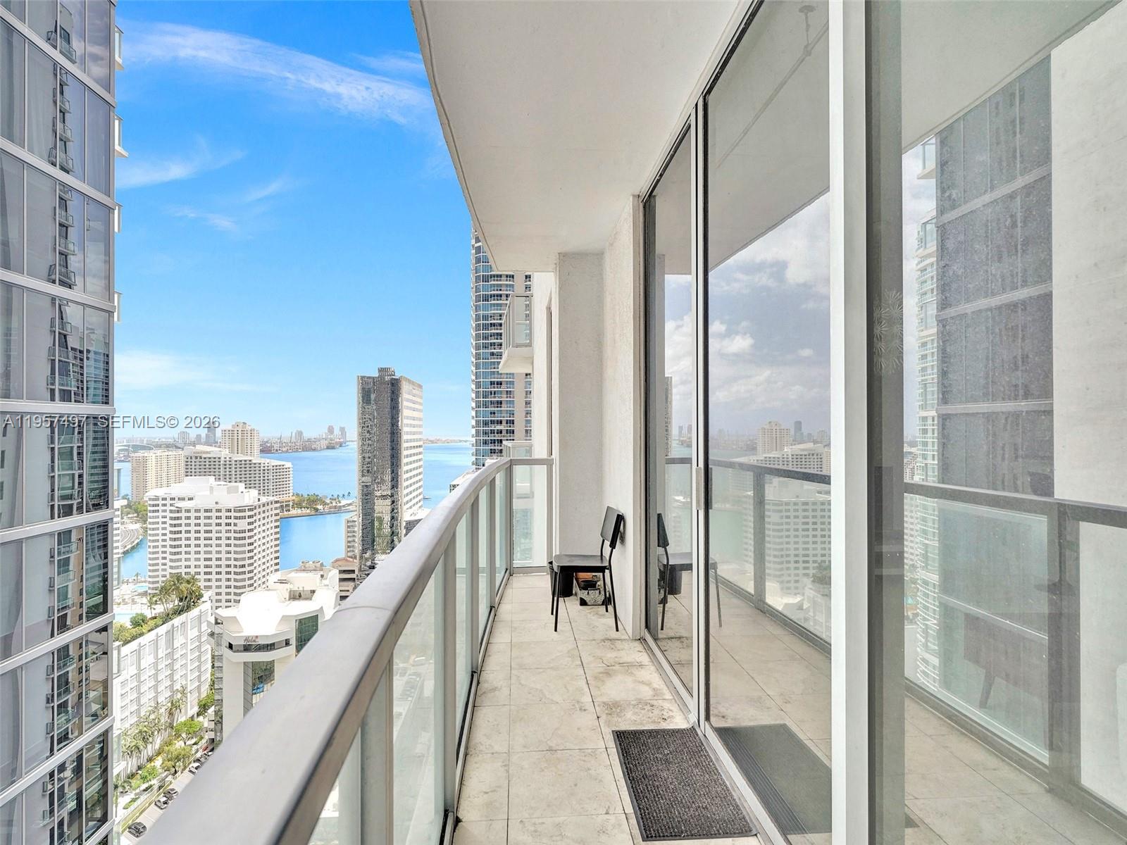 1050 Brickell Avenue, Unit 2722 Miami, FL 33131 - Photo 18 of 19 a balcony with view of living room and wooden floor