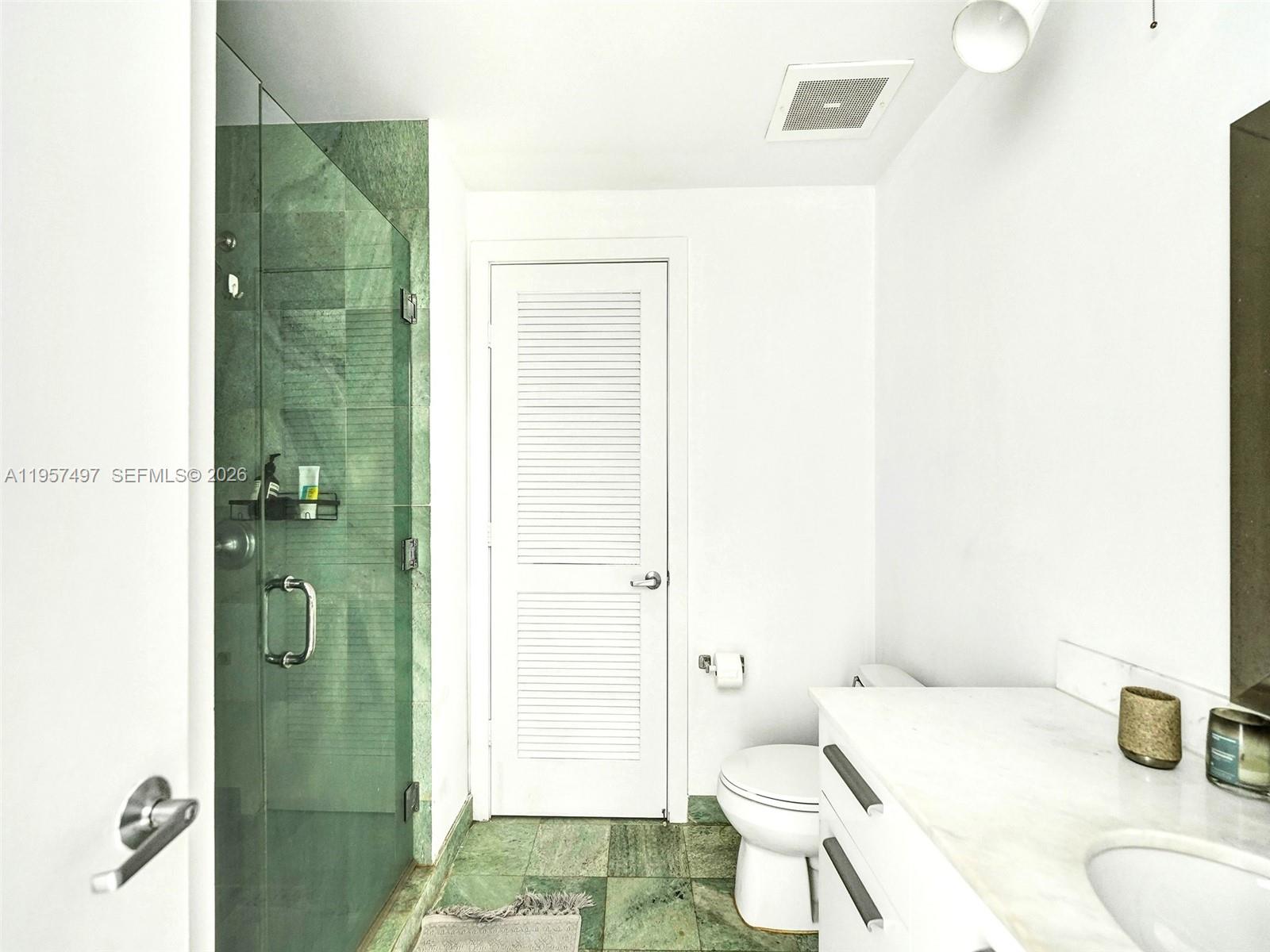 1050 Brickell Avenue, Unit 2722 Miami, FL 33131 - Photo 9 of 19 a bathroom with a sink a toilet and shower