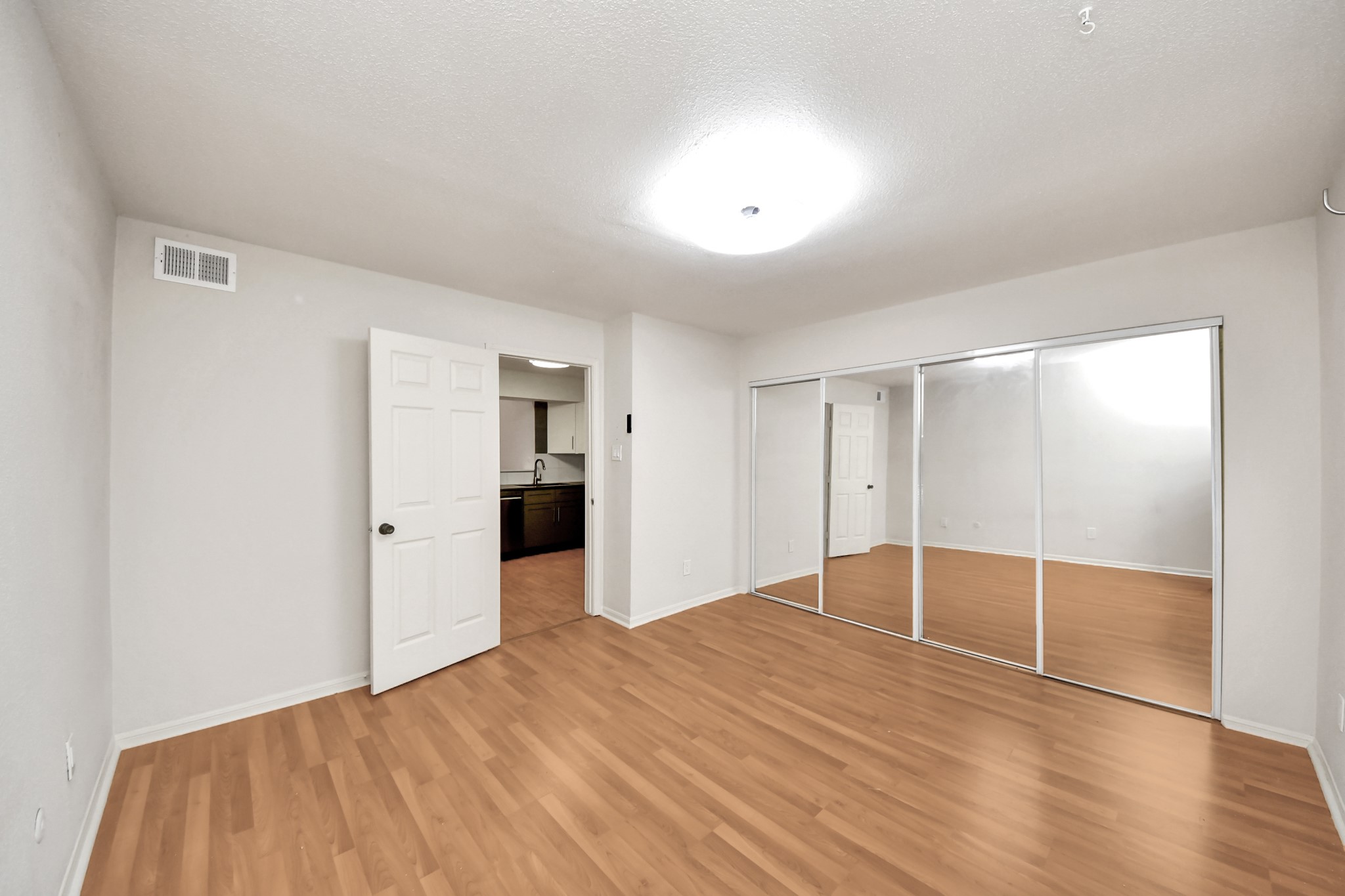 2425 Holly Hall Street, Unit C54 Houston, TX 77054 - Photo 13 of 22 a view of empty room with wooden floor