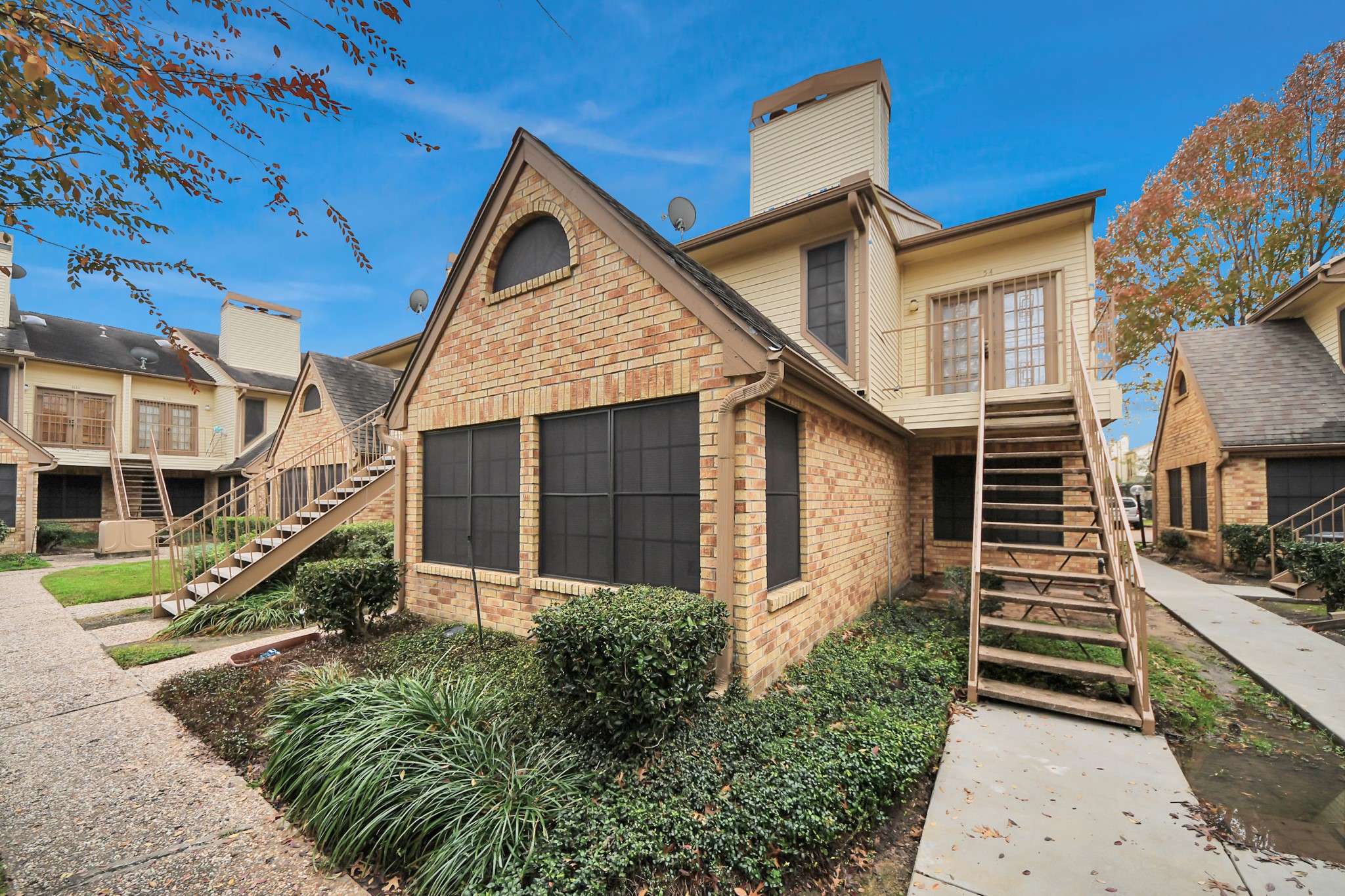 2425 Holly Hall Street, Unit C54 Houston, TX 77054 - Photo 17 of 22 a front view of a house with a yard