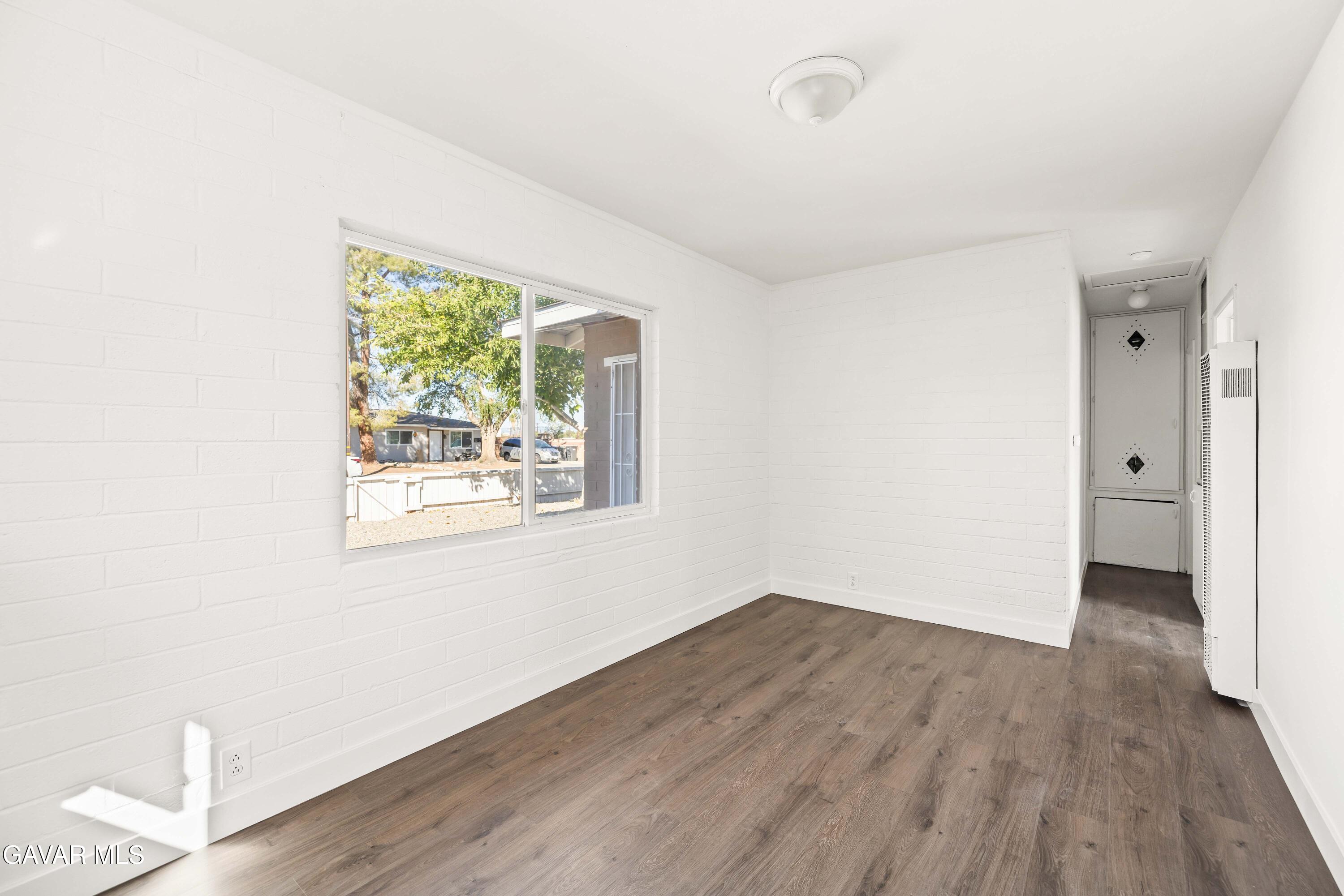 45148 Date Avenue Lancaster, CA 93534 - Photo 19 of 32 wooden floor in an empty room with a window