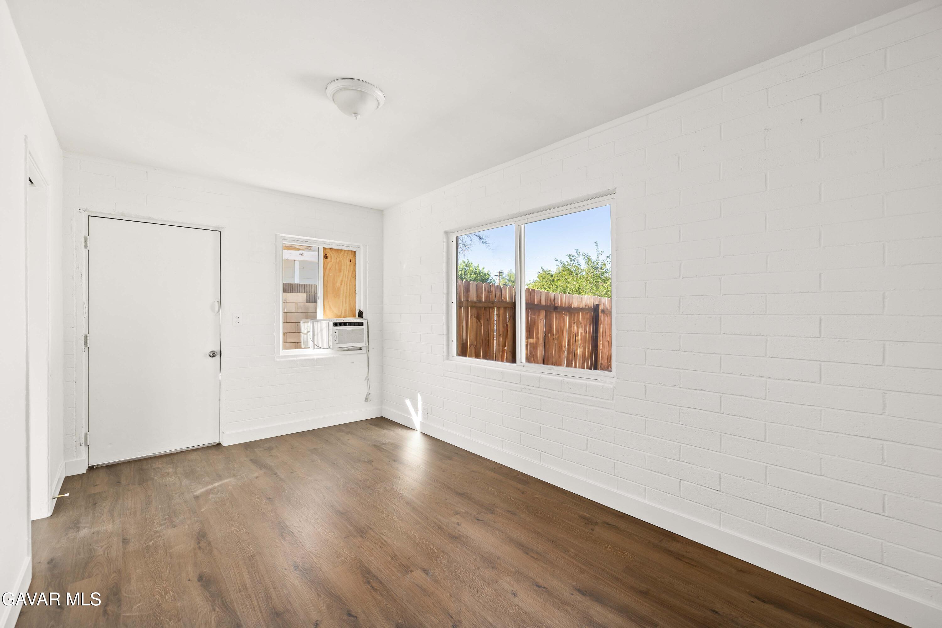 45148 Date Avenue Lancaster, CA 93534 - Photo 20 of 32 an empty room with wooden floor and windows