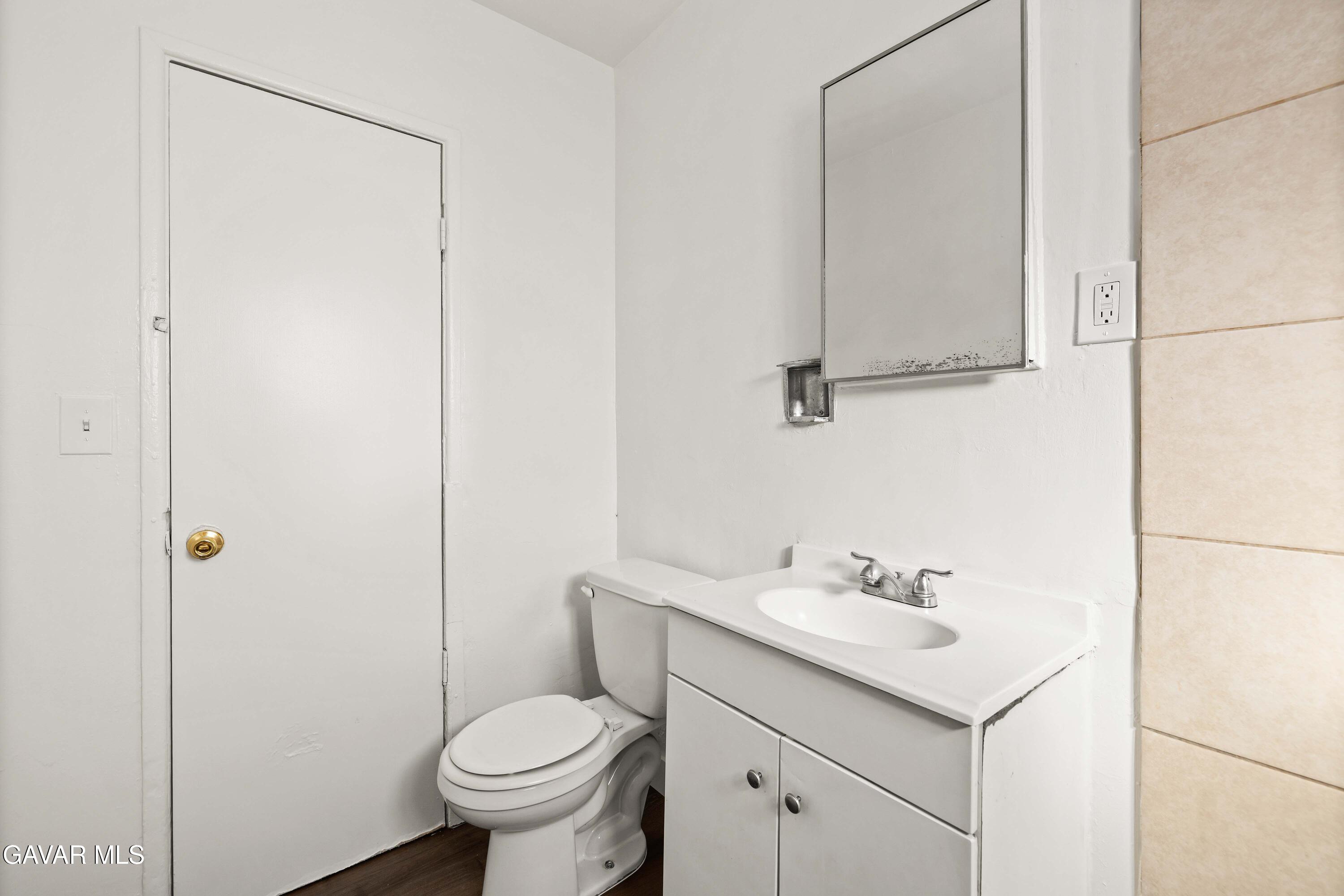 45148 Date Avenue Lancaster, CA 93534 - Photo 24 of 32 a bathroom with a sink toilet and vanity