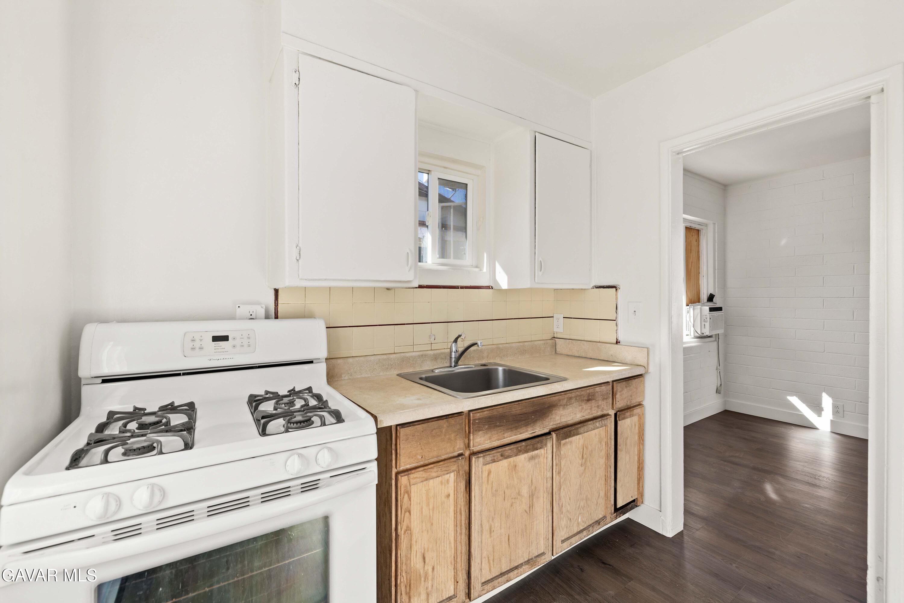 45148 Date Avenue Lancaster, CA 93534 - Photo 27 of 32 a kitchen with a sink stove and cabinets