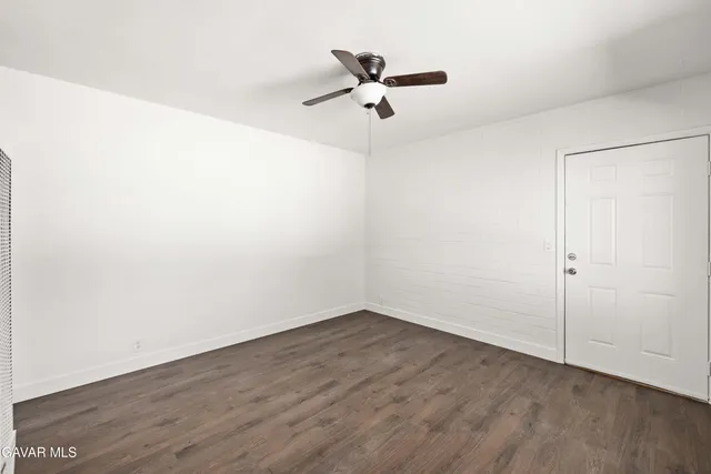 a view of a room with wooden floor