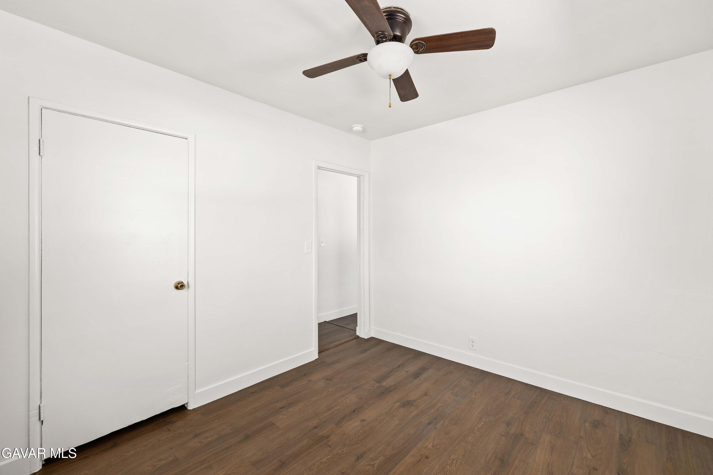 45148 Date Avenue Lancaster, CA 93534 - Photo 7 of 32 an empty room with wooden floor