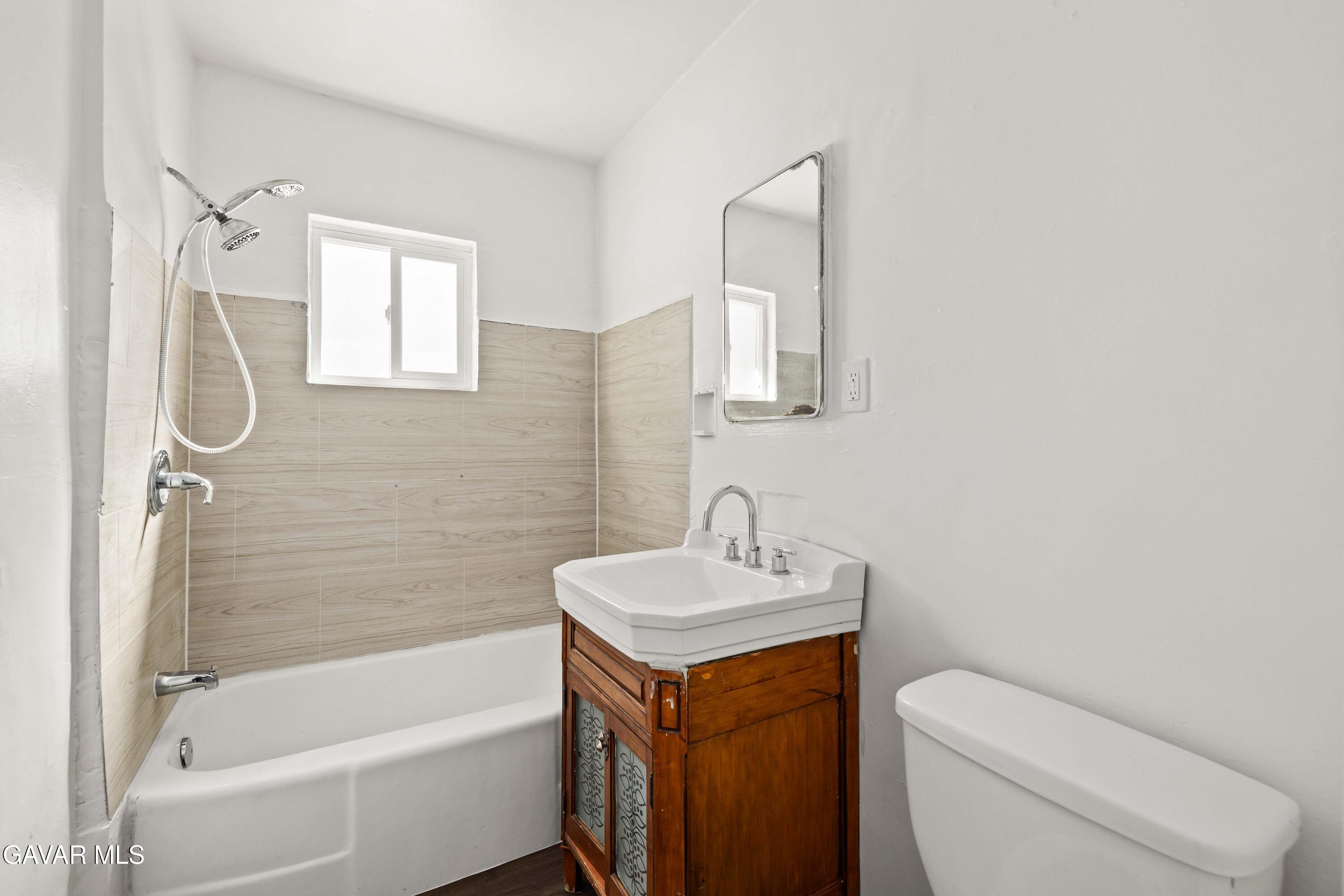 45148 Date Avenue Lancaster, CA 93534 - Photo 9 of 32 a bathroom with a sink toilet and shower