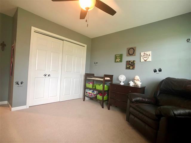 9987 East High Road Stillman Valley, IL 61084 - Photo 15 of 25 a living room with furniture and a chandelier