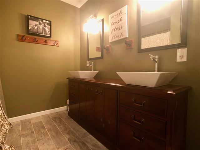 9987 East High Road Stillman Valley, IL 61084 - Photo 17 of 25 a bathroom with a sink and a mirror