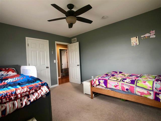 9987 East High Road Stillman Valley, IL 61084 - Photo 19 of 25 a bedroom with a bed and a dresser