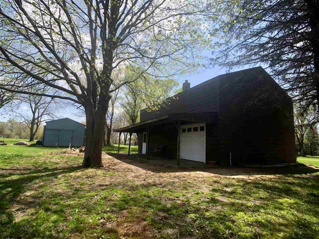 9987 East High Road Stillman Valley, IL 61084 - Photo 3 of 25 a house with trees in front of it