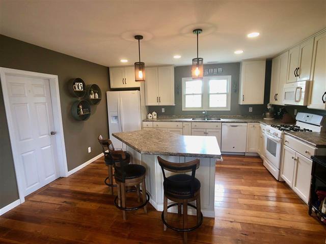 9987 East High Road Stillman Valley, IL 61084 - Photo 10 of 25 a large kitchen with granite countertop lots of counter space and window