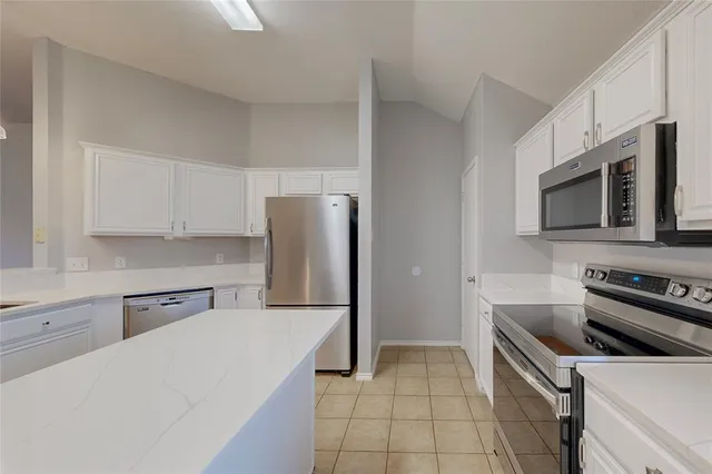 a kitchen with a refrigerator stove and microwave