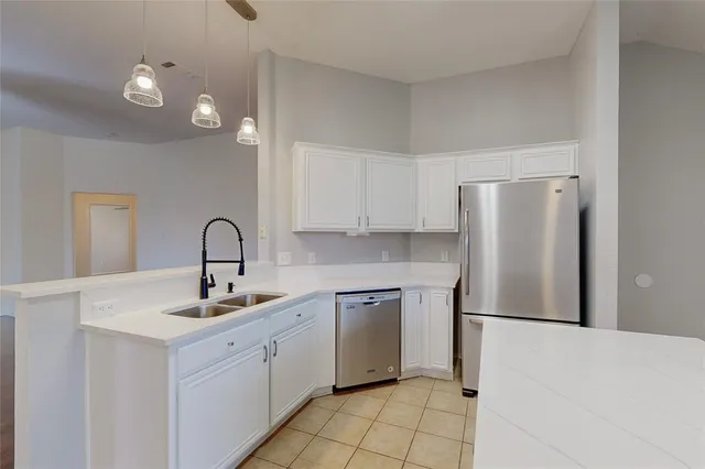 a kitchen with a sink cabinets and appliances