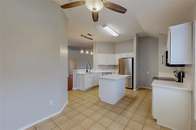 a kitchen with a sink and refrigerator