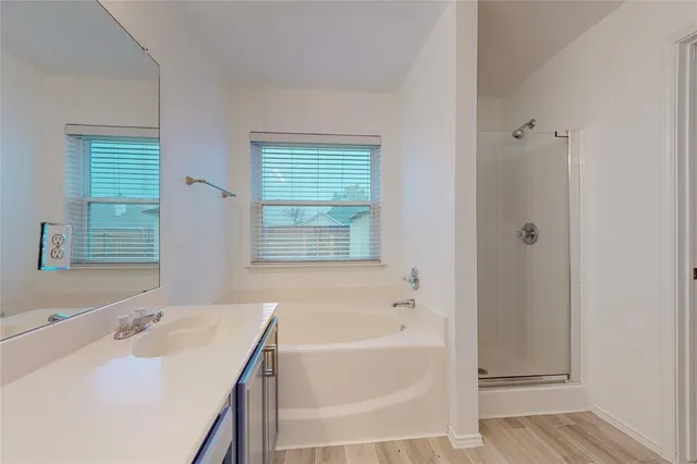 a bathroom with a tub sink and a window