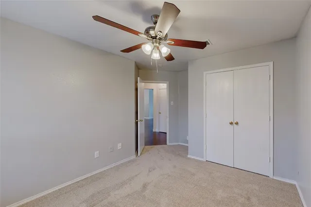 an empty room and chandelier fan