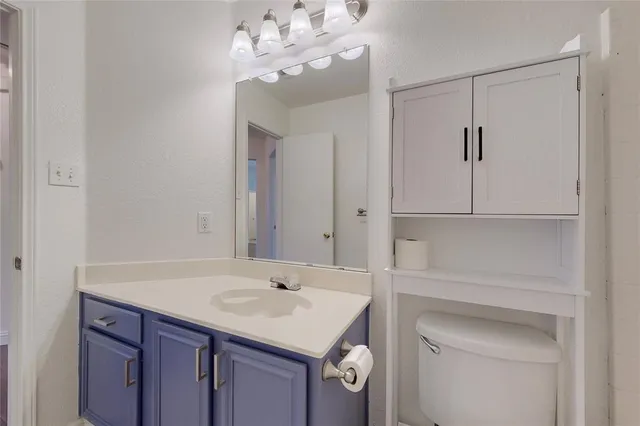 a bathroom with a sink vanity and a mirror