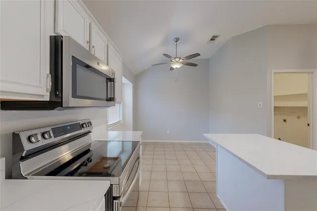 a kitchen with a sink a stove and cabinets