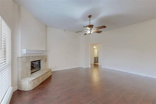 an empty room with a fireplace and fan