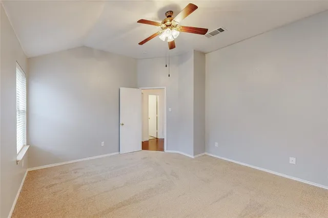 a view of a big room with closet and a chandelier fan