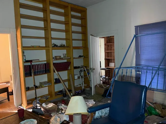 a living room with furniture and a mirror