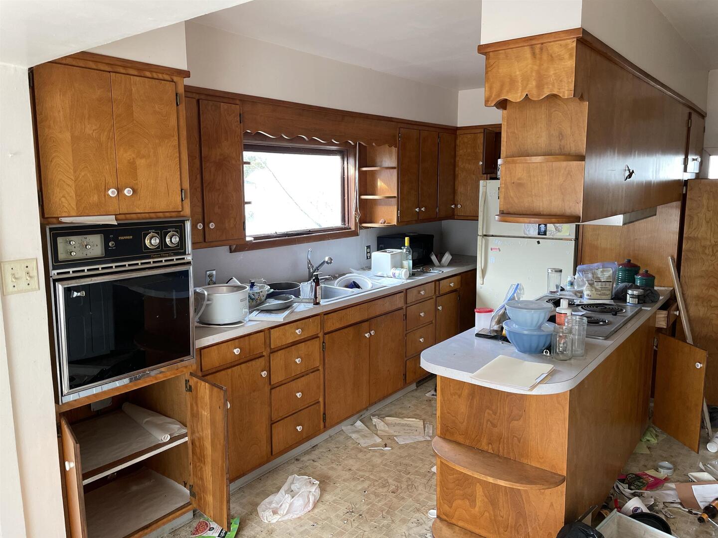 209 South 16th Street Herrin, IL 62948 - Photo 6 of 38 a kitchen with sink refrigerator and stove