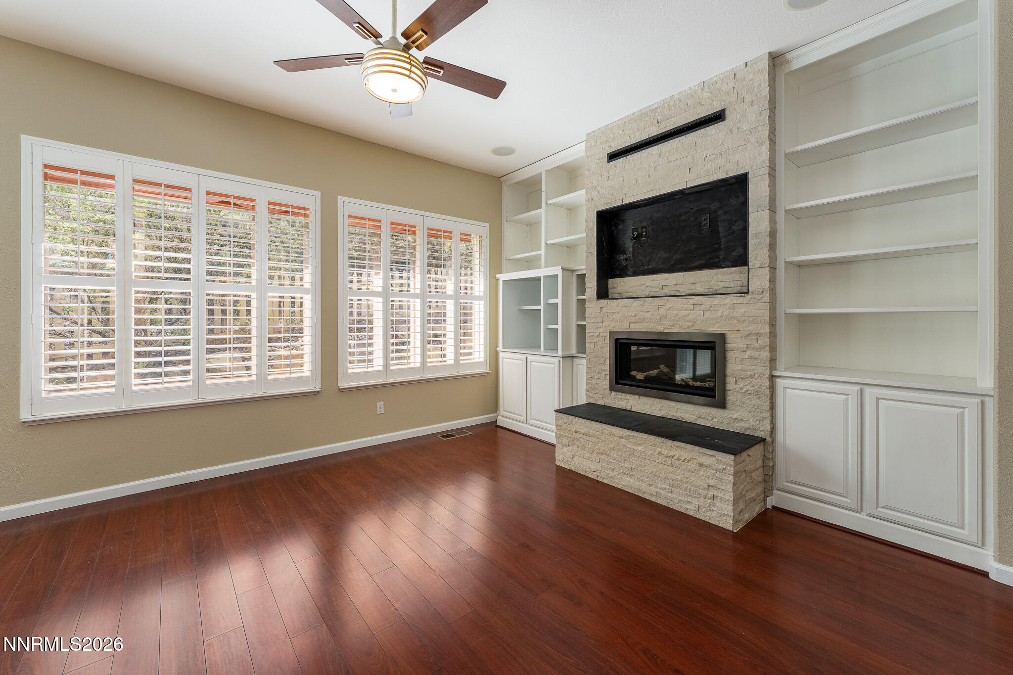 1840 Hunter Creek Road Reno, NV 89519 - Photo 9 of 39 a view of wooden floor fire place and windows in a room