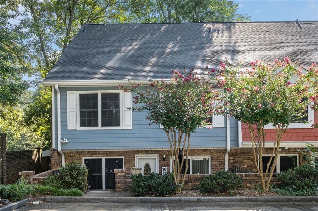 a front view of a house with plants