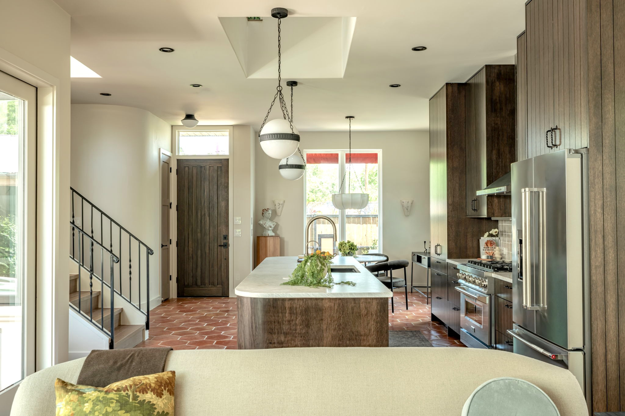 4713 Bolm Road Austin, TX 78702 - Photo 9 of 40 Open-concept living area featuring a kitchen with stainless steel appliances, a center island, and wood-finish cabinetry