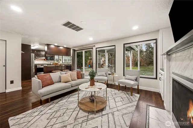 a living room with furniture fireplace and a flat screen tv