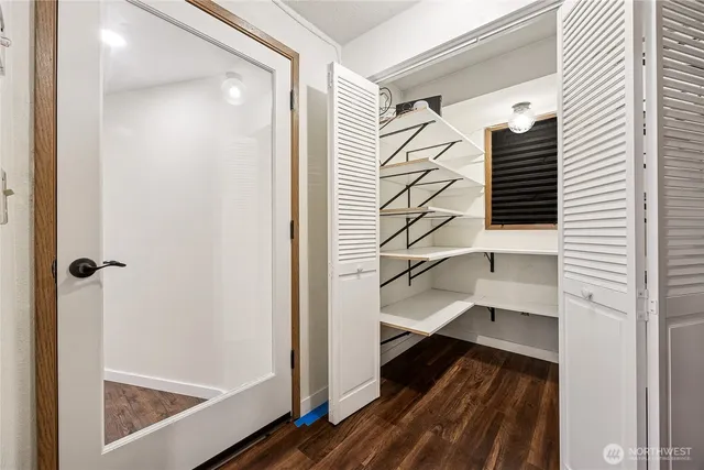a view of a hallway with wooden floor and entryway