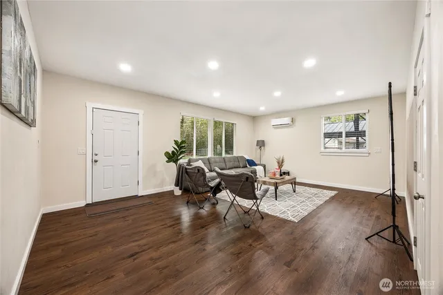 a living room with furniture and a wooden floor