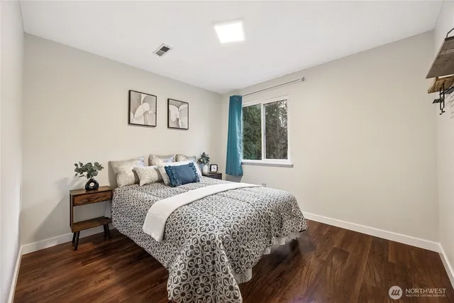 a bedroom with a bed and a night stand