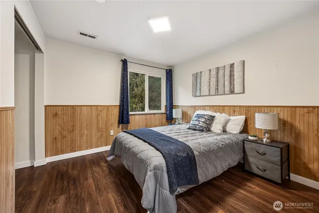 a bedroom with a bed and a night stand