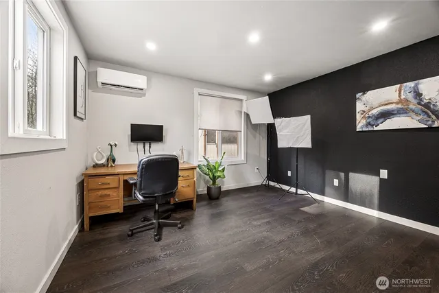 a view of a workspace with furniture and a window