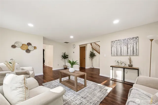 a living room with furniture and wooden floor