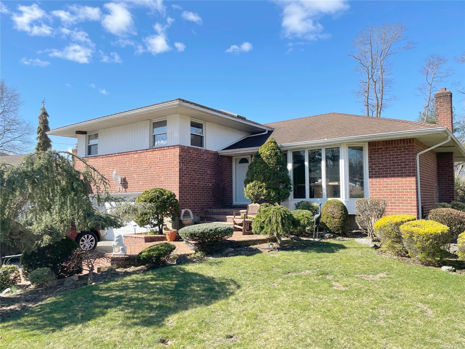 21 Roxton Road Plainview, NY 11803 - Photo 1 of 1 a front view of a house with sitting area