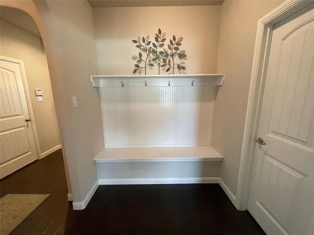 a spacious bedroom with a bed and a chandelier