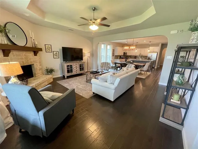 a living room with furniture a flat screen tv and a fireplace