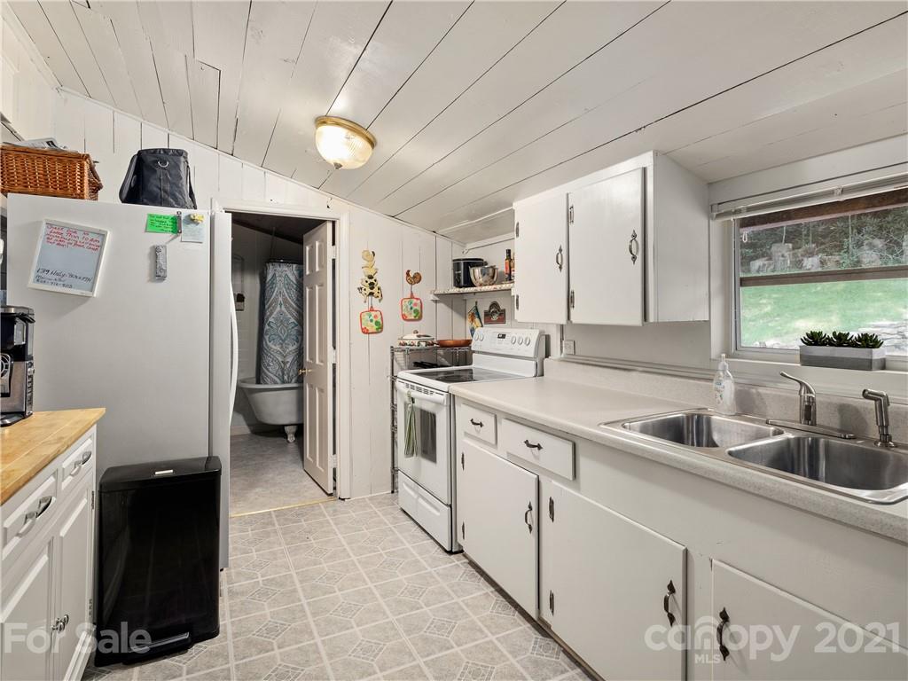 139 Holly Road Black Mountain, NC 28711 - Photo 11 of 21 a kitchen with a sink and refrigerator