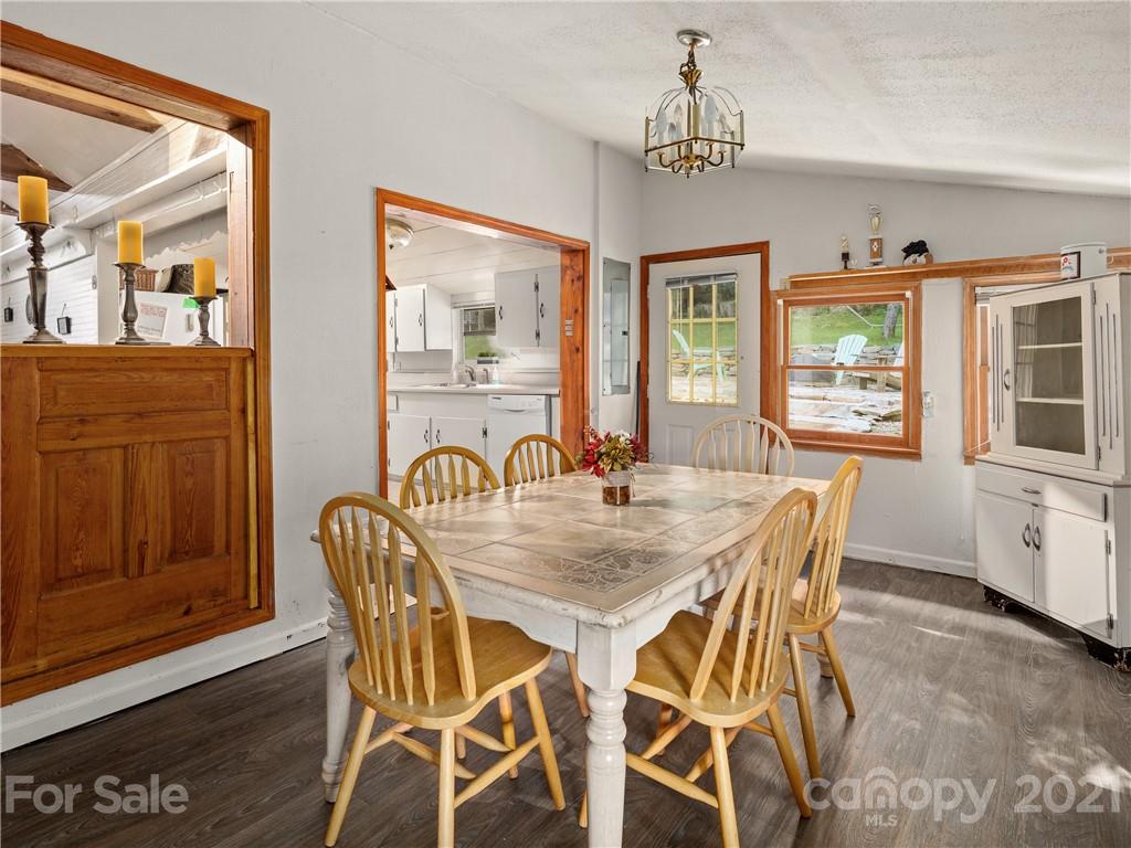 139 Holly Road Black Mountain, NC 28711 - Photo 14 of 21 a view of a dining room with furniture window and wooden floor