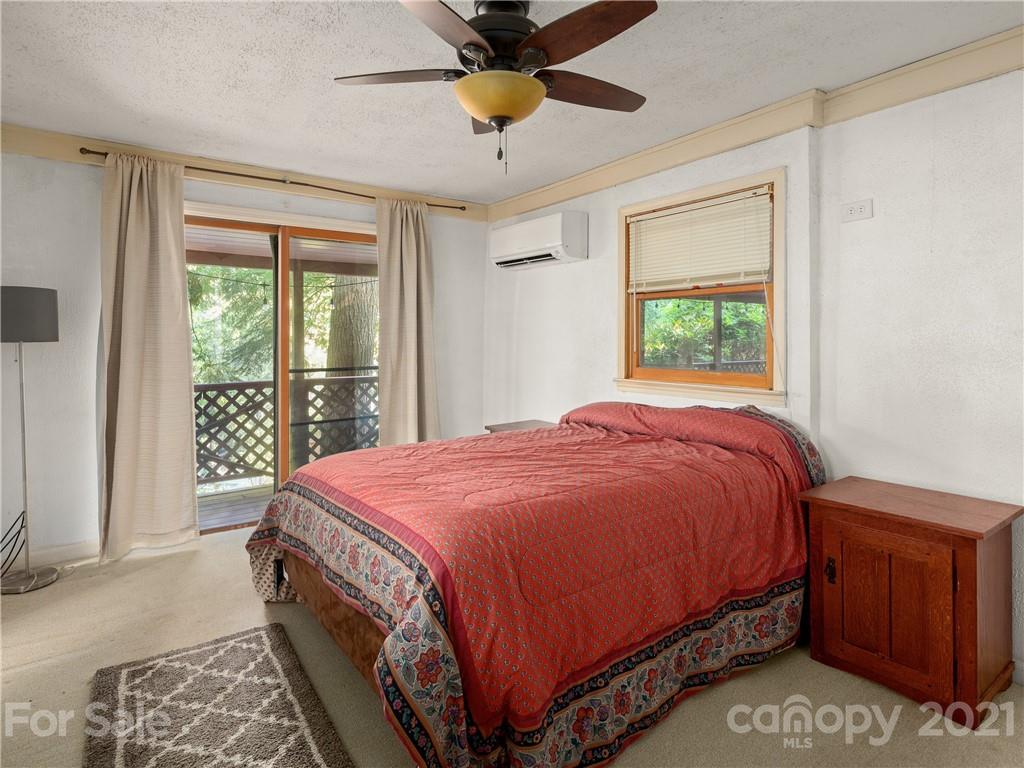 139 Holly Road Black Mountain, NC 28711 - Photo 15 of 21 a bedroom with a bed and window
