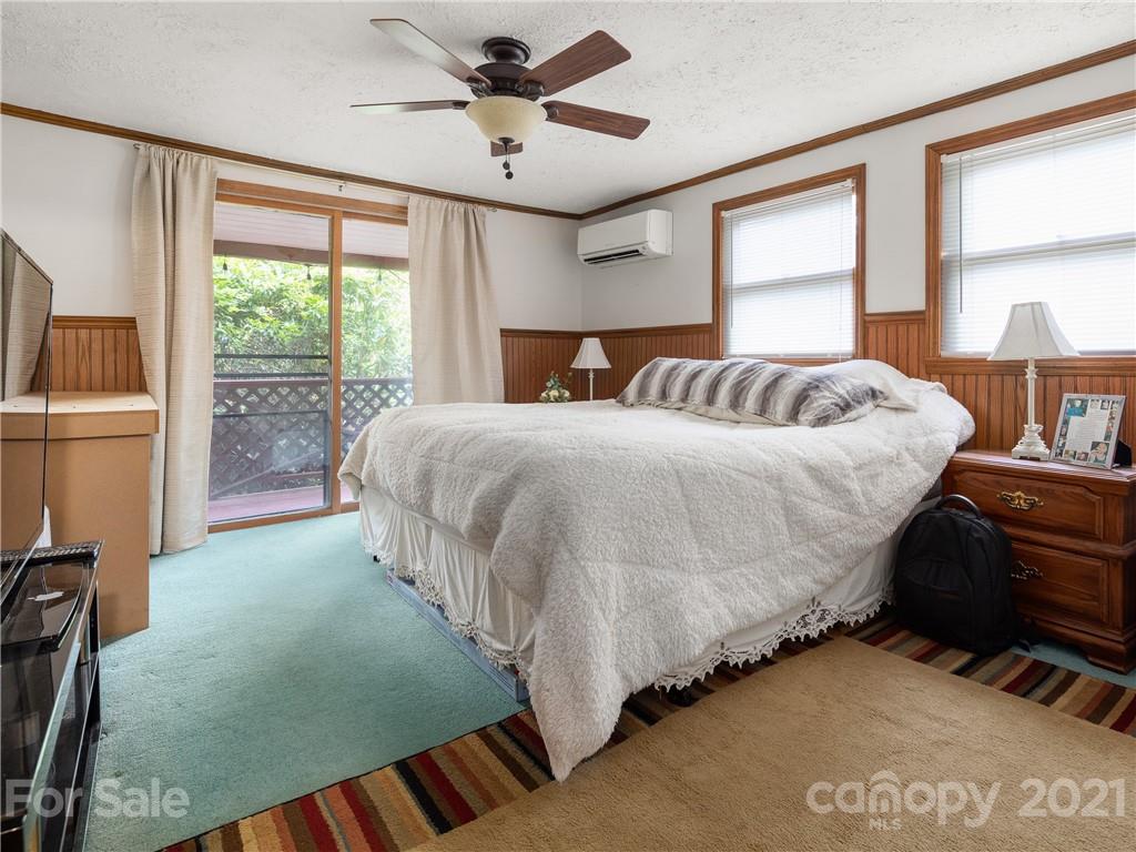 139 Holly Road Black Mountain, NC 28711 - Photo 17 of 21 a bedroom with a bed lamps and window