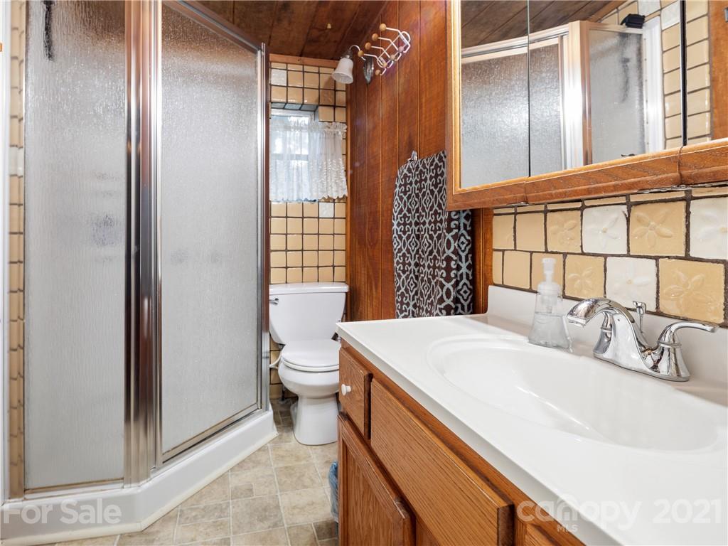 139 Holly Road Black Mountain, NC 28711 - Photo 18 of 21 a bathroom with a sink and a toilet
