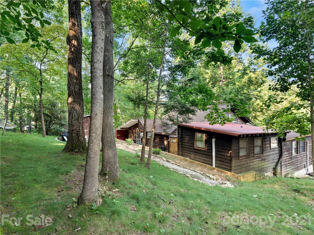 139 Holly Road Black Mountain, NC 28711 - Photo 19 of 21 a view of a house with a backyard porch and sitting area