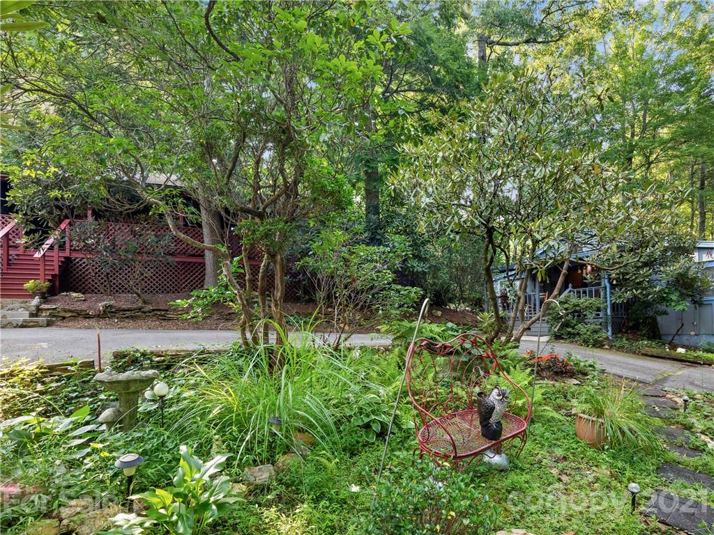 139 Holly Road Black Mountain, NC 28711 - Photo 3 of 21 a backyard of a house with lots of green space