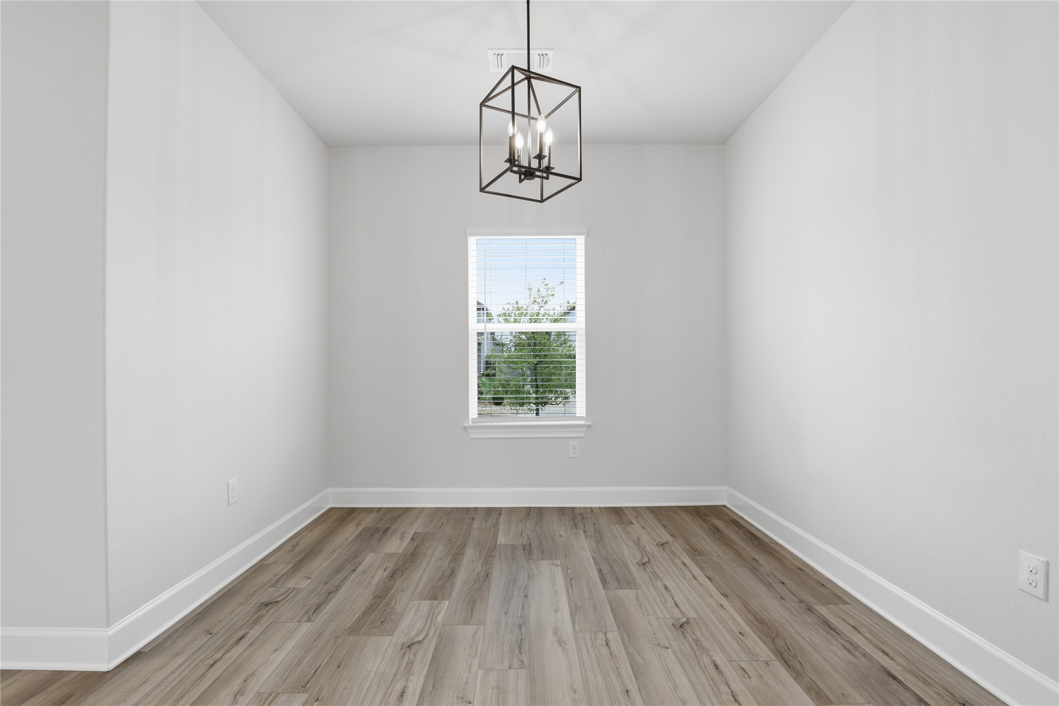9320 Gladsome Path Manor, TX 78653 - Photo 24 of 34 a view of a room with wooden floor cabinets and a window