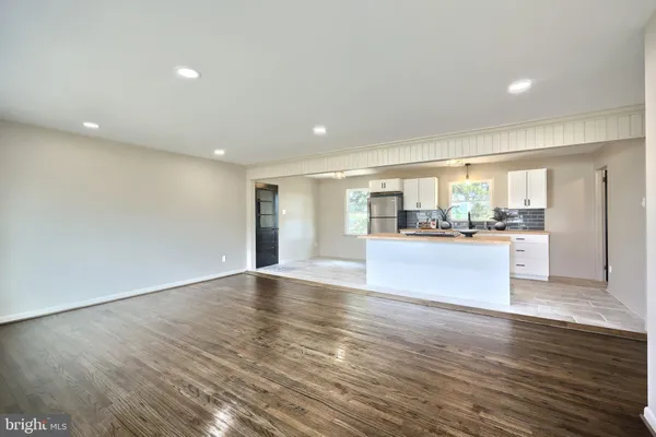 a view of kitchen with cabinets and wooden floor