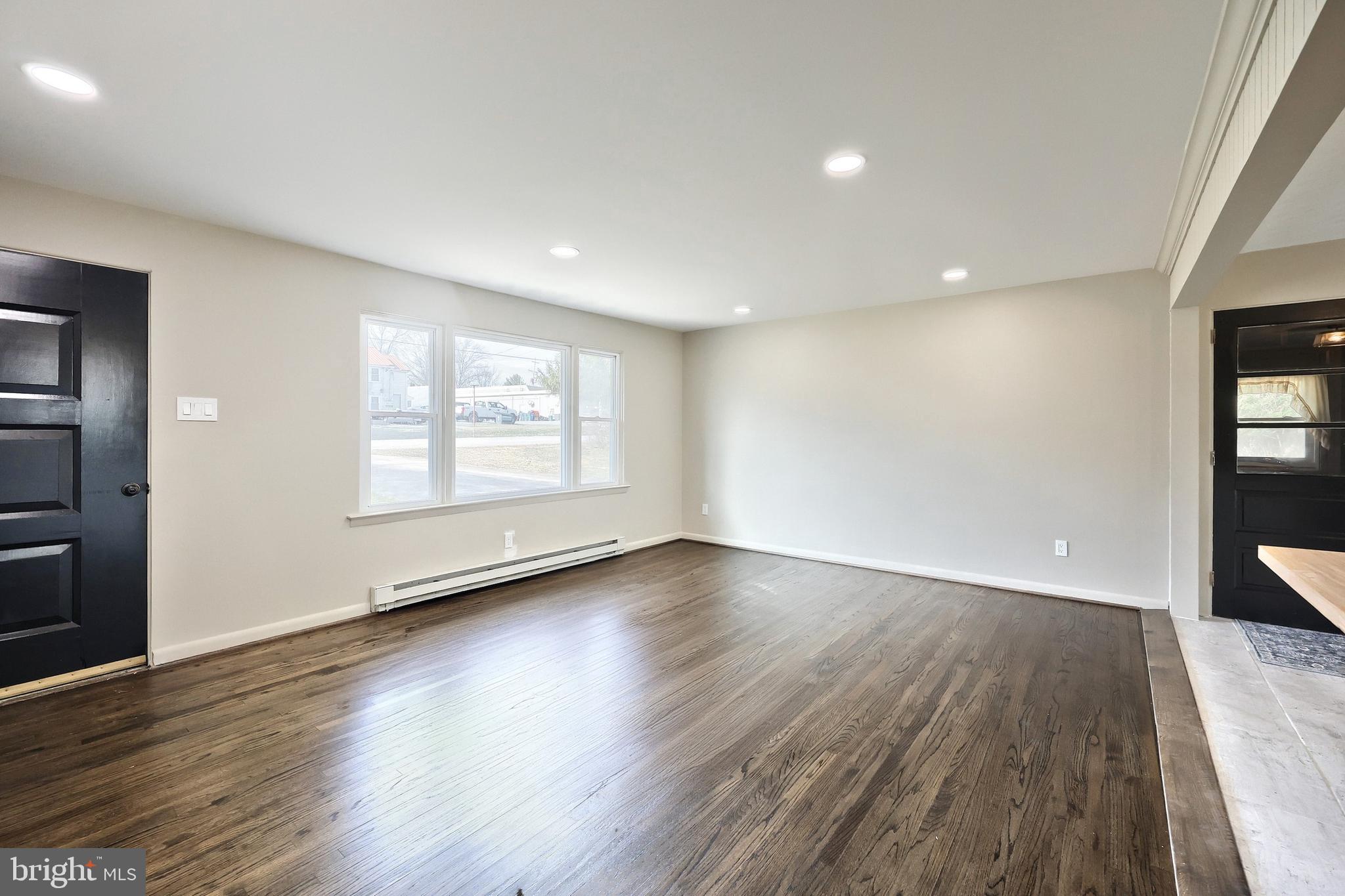 880 Springvale Road Red Lion, PA 17356 - Photo 13 of 39 an empty room with wooden floor and windows